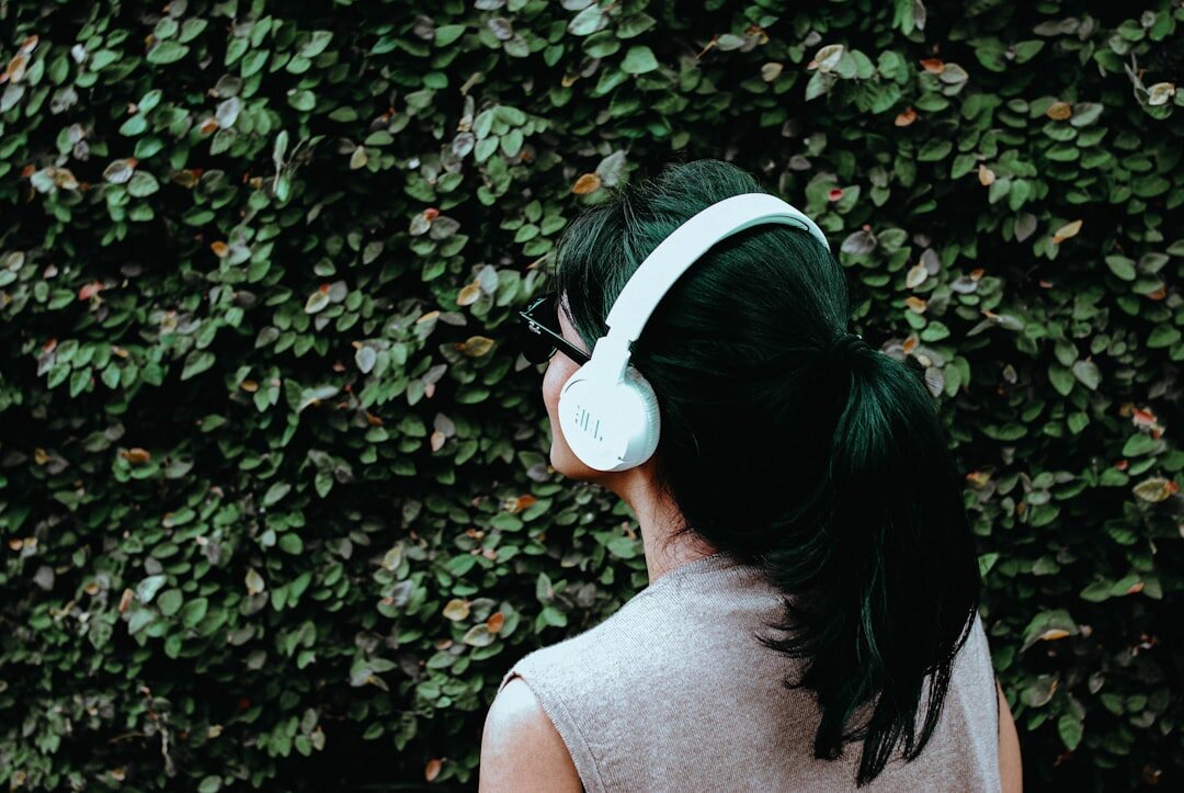 person listening to podcast with headphones