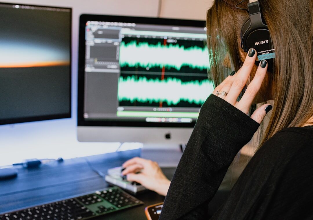 woman editing audio on computer